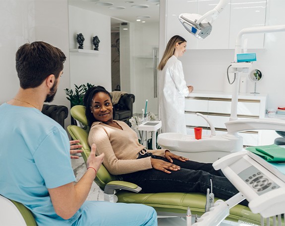 a dentist speaking with a patient about dental implants