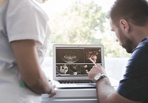 a dentist looking at X-rays on a computer