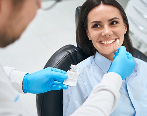 Dental receptionist helping patient